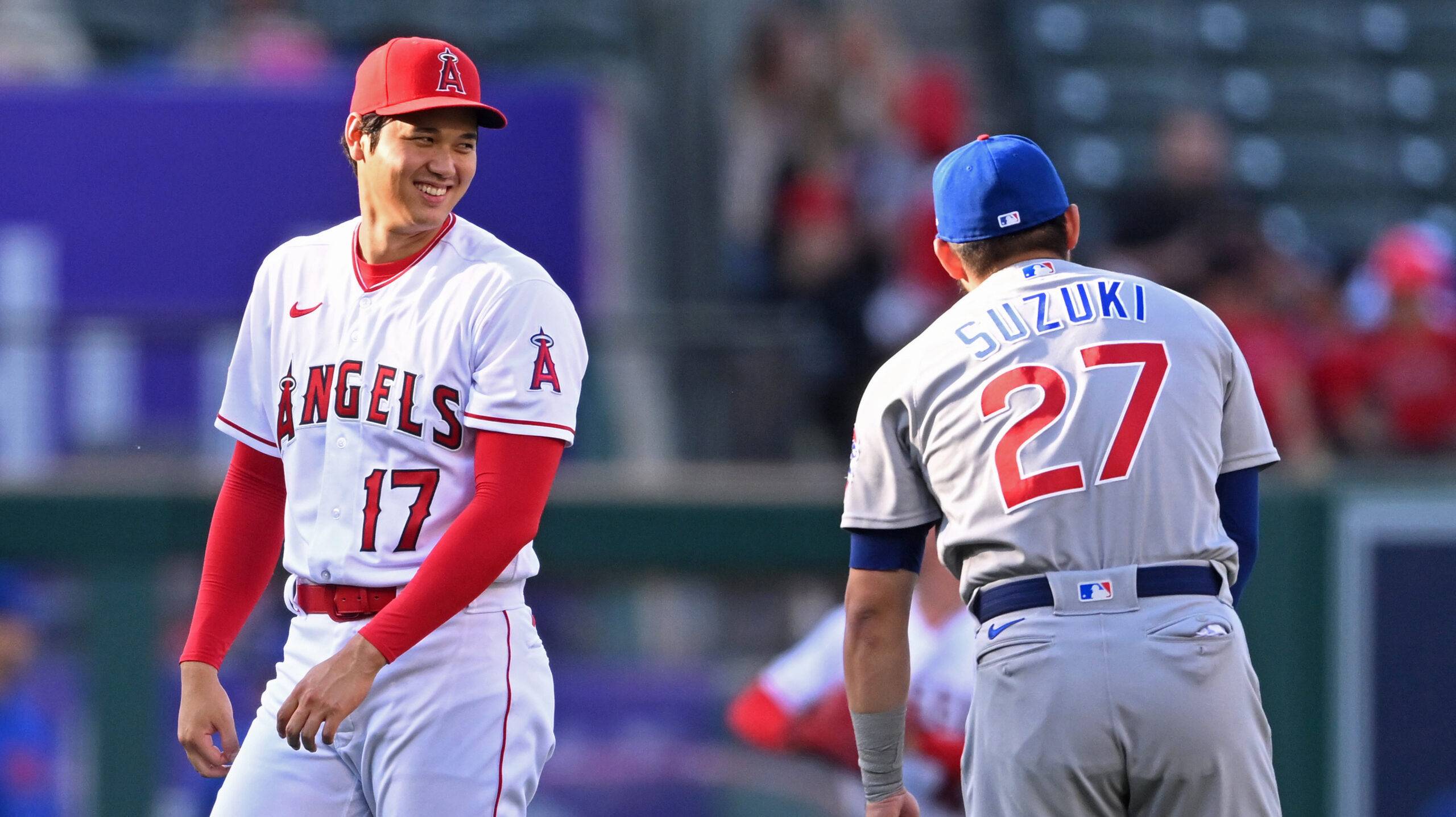 Los Angeles Angels designated hitter Shohei Ohtani (17) talks with Chicago Cubs right fielder Seiya Suzuki (27)
