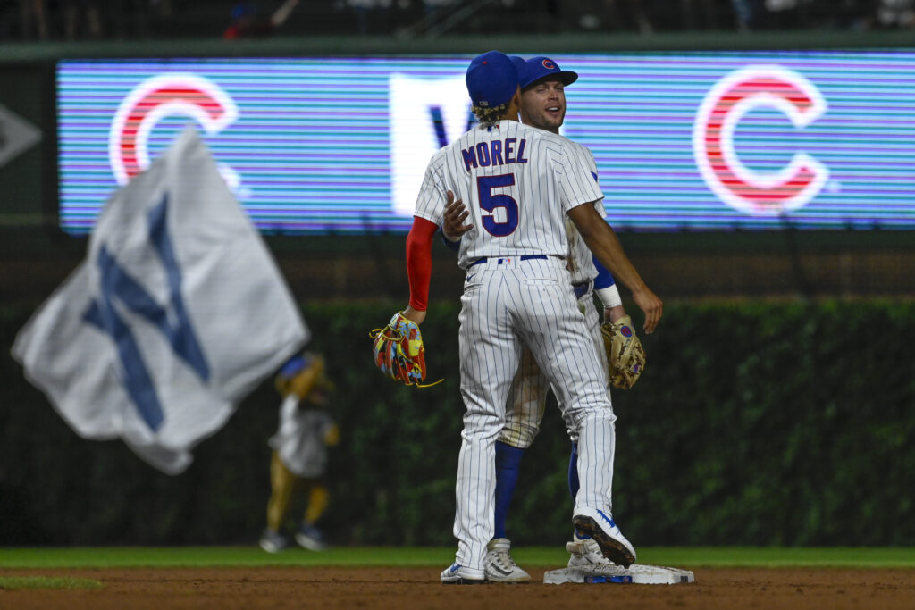 Chicago Cubs second baseman Nico Hoerner, back, celebrates with center fielder Christopher Morel (5) at the end of the game against the Washington Nationals at Wrigley Field.