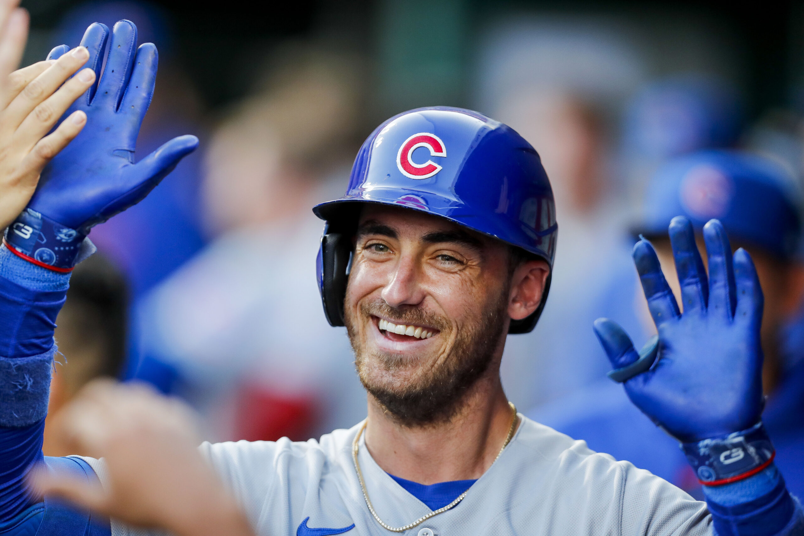 Chicago Cubs first baseman Cody Bellinger (24) high fives teammates after hitting a solo home run in the third inning against the Cincinnati Reds at Great American Ball Park.